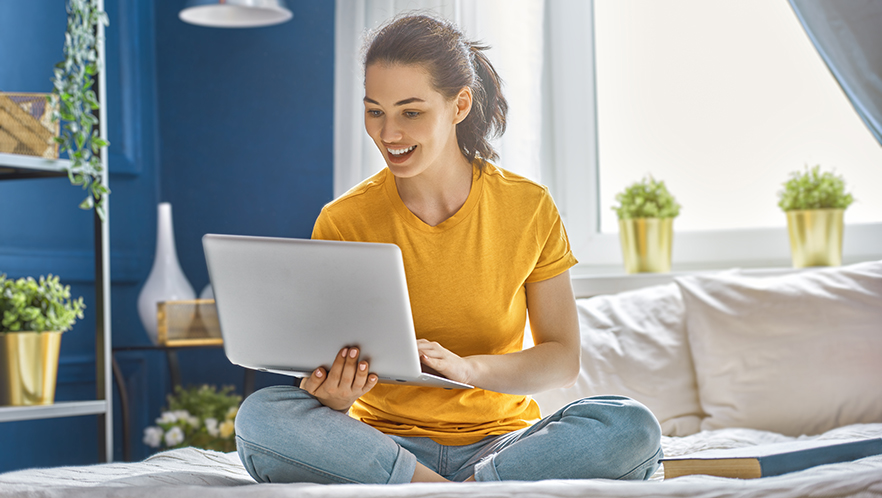 Smiling_woman_with_laptop_shutterstock_745659766.jpg
