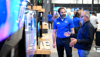 Energy Awareness Month: A Best Buy sales associate looks at TVs with a customer.