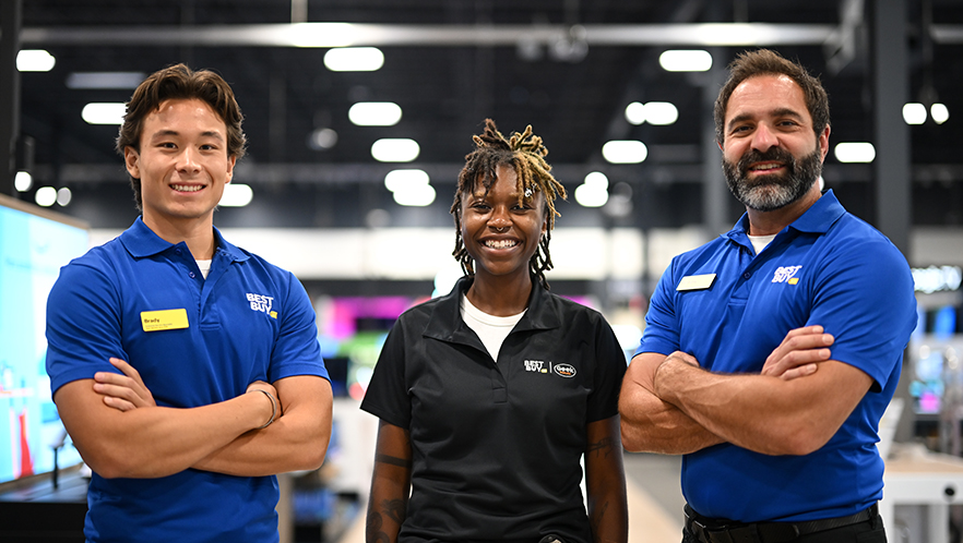 A photo of three employees in a Best Buy store